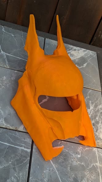 Orange 3D printed helmet project in progress